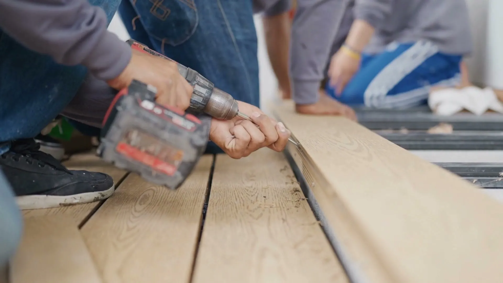 Crew fastening decking boards