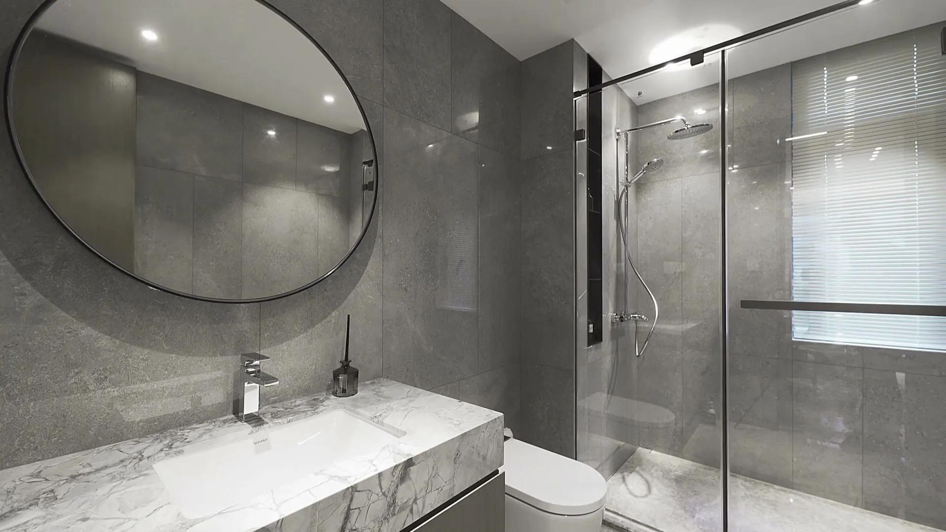 Finished bathroom with a glass shower and stone vanity